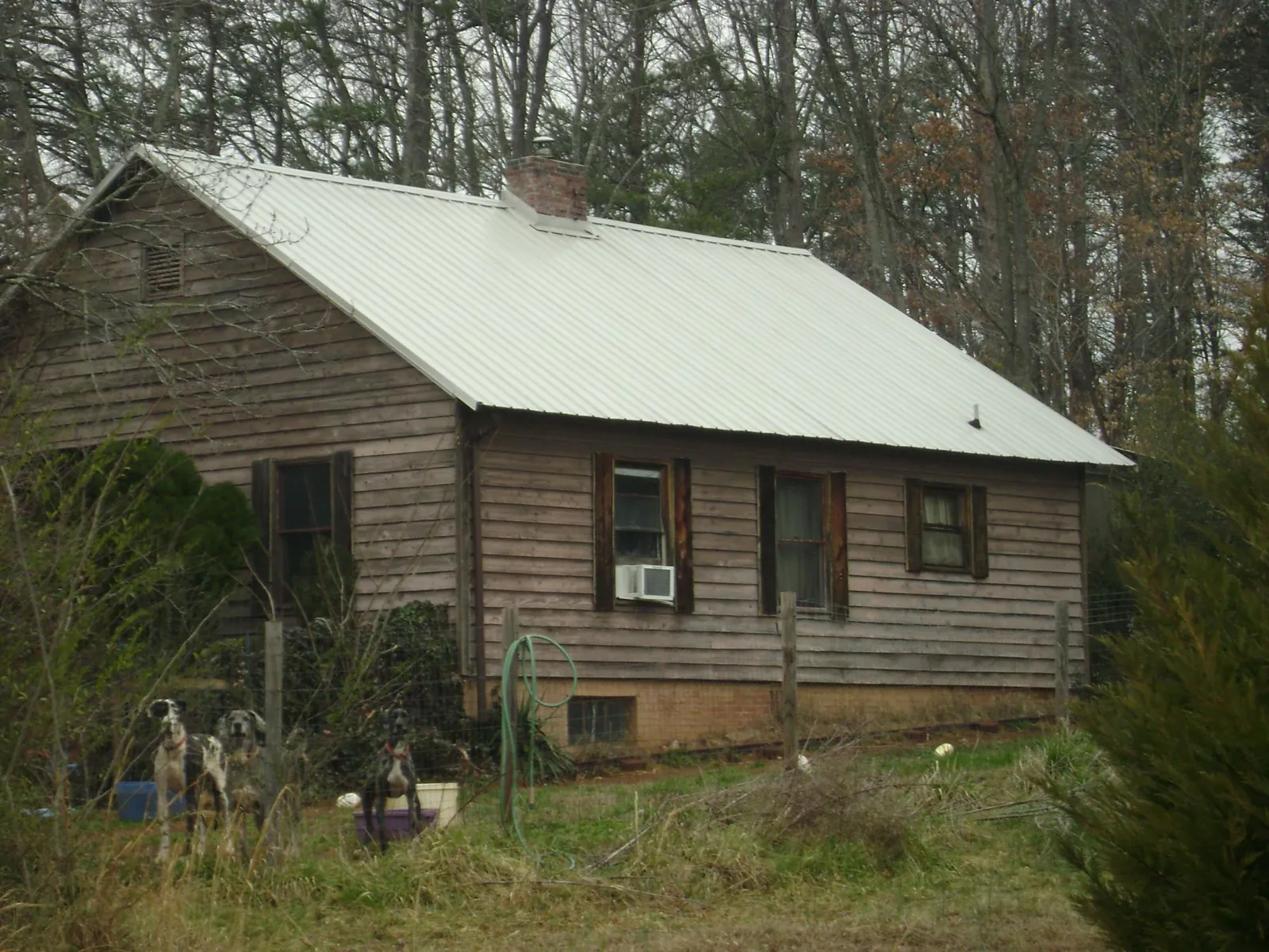 White metal roof on an old wood sided farmhouse, from a Metal Roof Installation job in Wyandotte